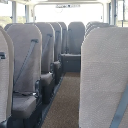 Seats and the centre aisle inside a Toyota Coaster
