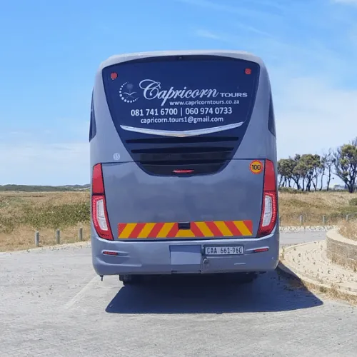 The back of the Irizar with the Capricorn Tours logo and phone numbers