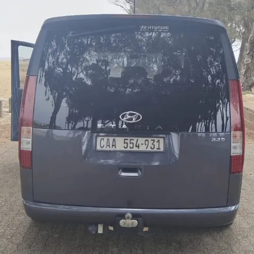 The back of the grey Hyundai Staria