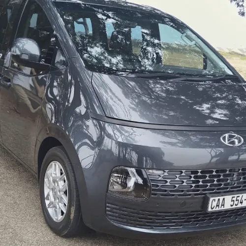 The grey Hyundai Staria from the front, at an angle