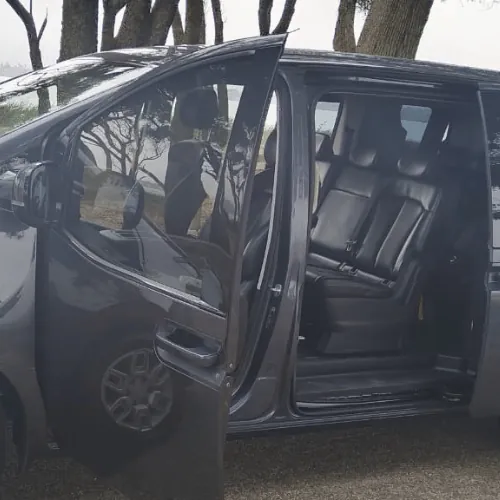 Seats inside the grey Staria, seen through the open door